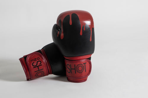 Red blood design dripped over a black leather boxing glove with red details 